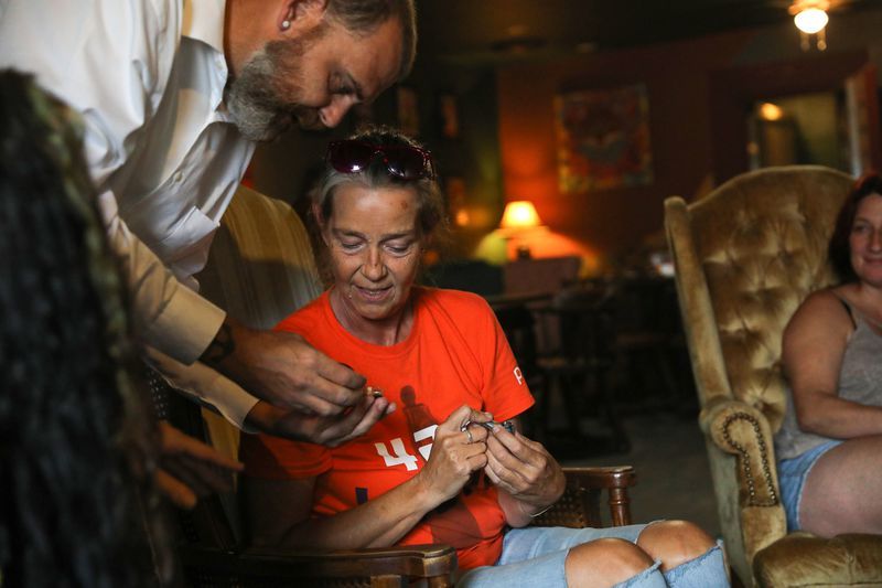Chris Duke, of Johnston City, Illinois, shows a cannabis product to Carla Curry, of Christopher, Illinois, at the Luna Lounge on July 15, 2021.