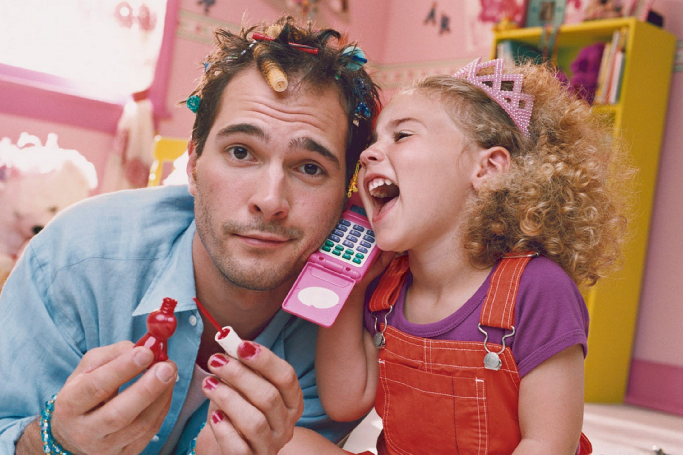 Daughter-playing-with-father-with-hair-curlers-and-nail-polish.jpg