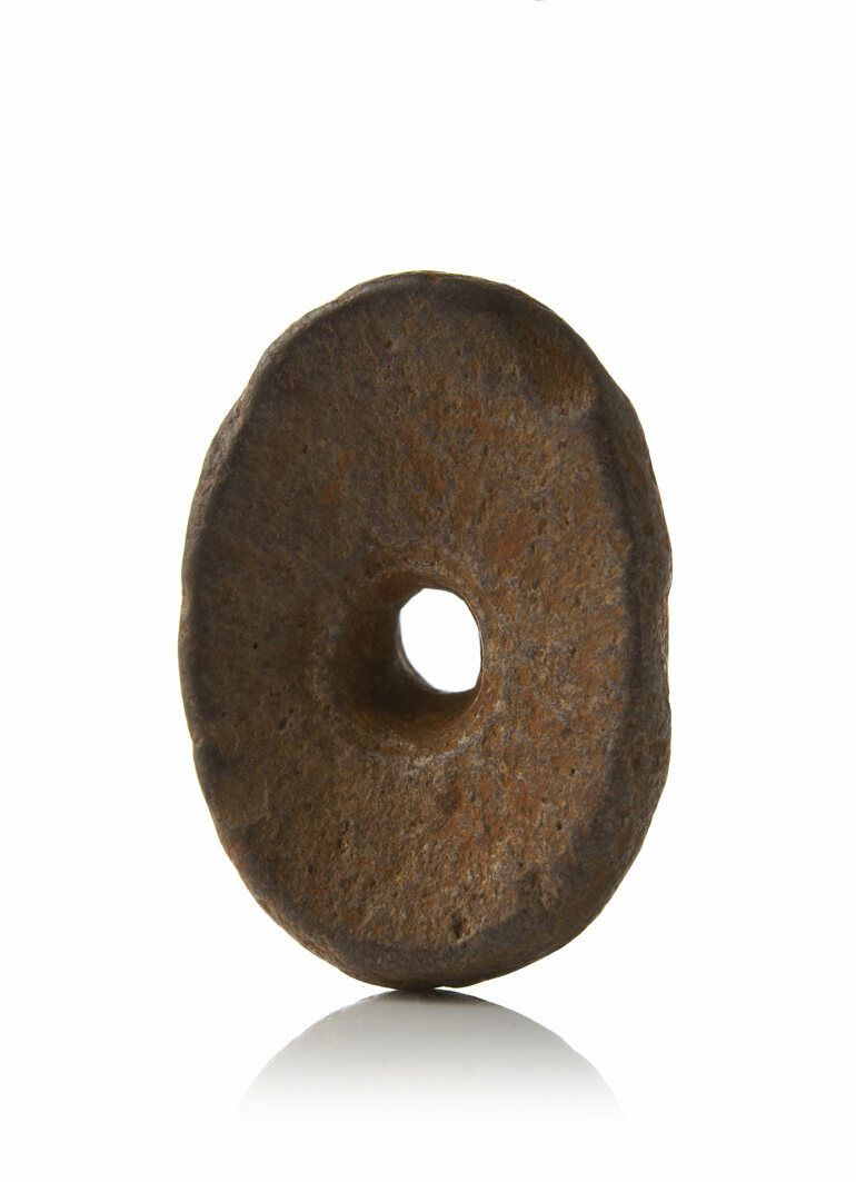 Like the museums' witch cakes, hag stones—which were hung in cottage doors for protection—also had a hole in the center. 