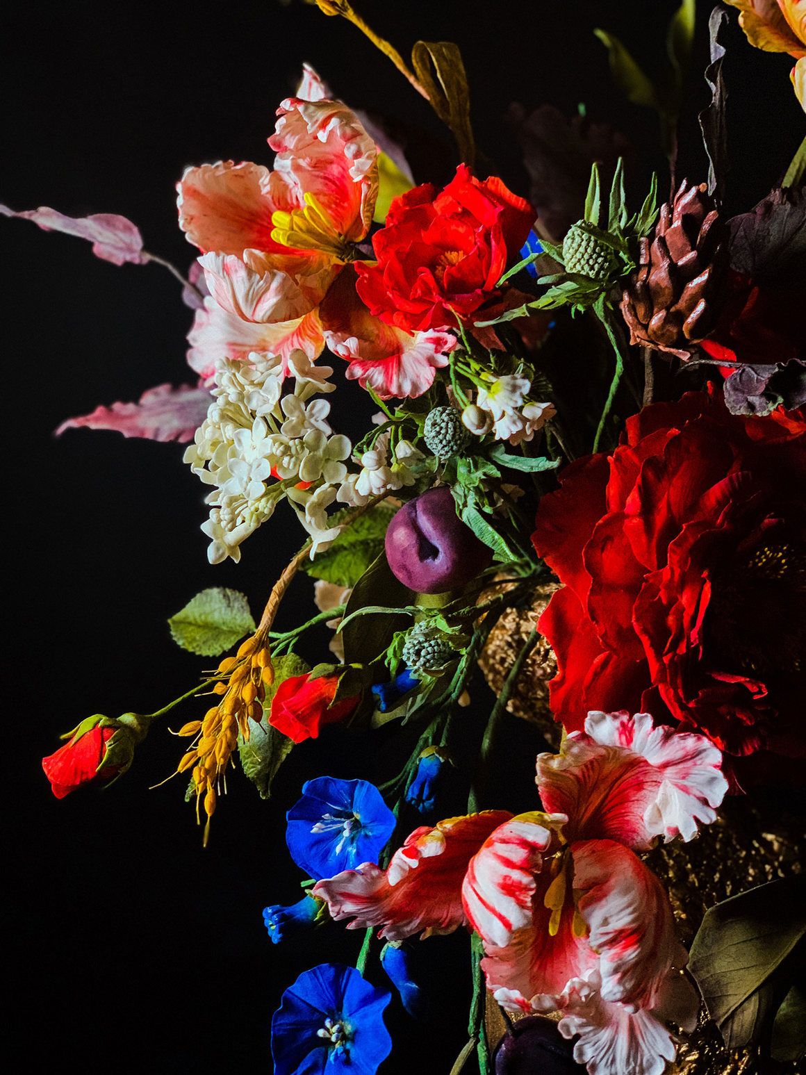 Simon's compositions are flights of floral fantasy. Here, a close-up of one such bouquet atop a cake.