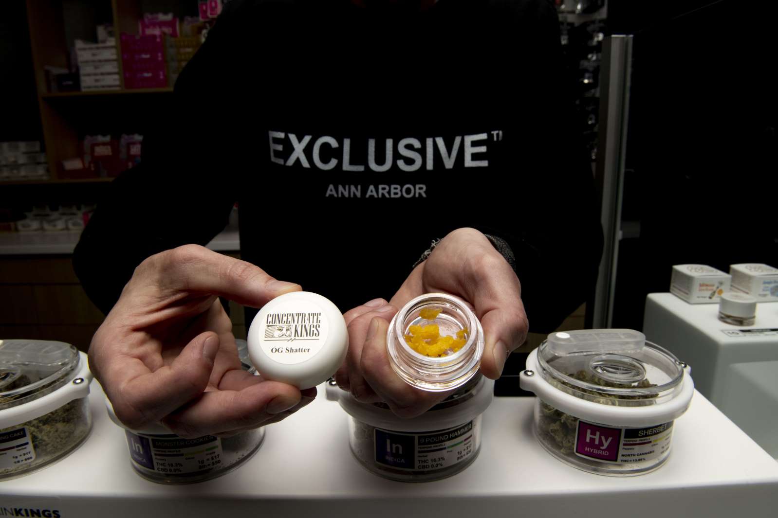 a cup of coffee on a table: Andrew Thomas shows products offered at Exclusive Brands while they are issued the first recreational marijuana license in the state of Michigan during a Marijuana Regulatory Agency press briefing on Tuesday Nov. 19, 2019 at 3820 Varsity Drive. Exclusive Brands will have their grand opening Friday and Saturday.