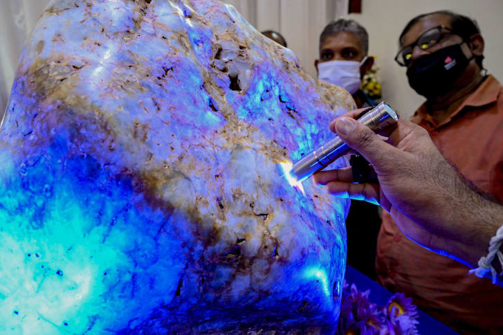 People inspect the blue sapphire, dubbed Queen of Asia, in Horana, Sri Lanka.