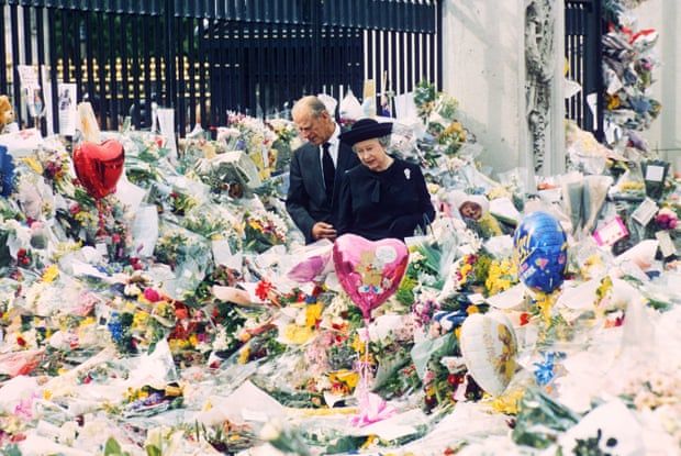 Prince Philip and Queen Elizabeth II look at the floral tributes left outside Buckingham Palace on the eve of the funeral of Diana in September 1997.