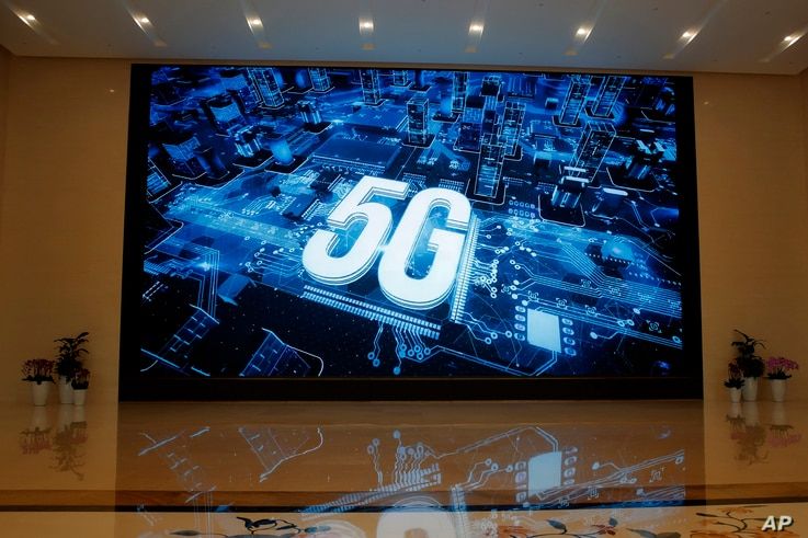 A 5G logo is displayed on a screen outside the showroom at Huawei campus in Shenzhen city, China