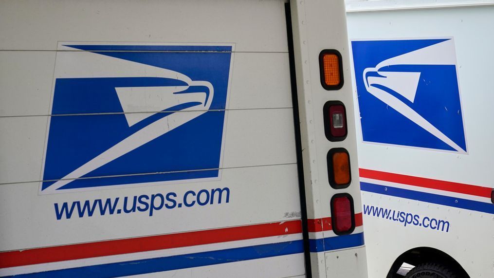 FILE - In this Aug. 18, 2020, file photo, mail delivery vehicles are parked outside a post office in Boys Town, Neb. (AP Photo/Nati Harnik, File)