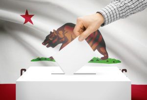 Image of a voting box in front of California state flag
