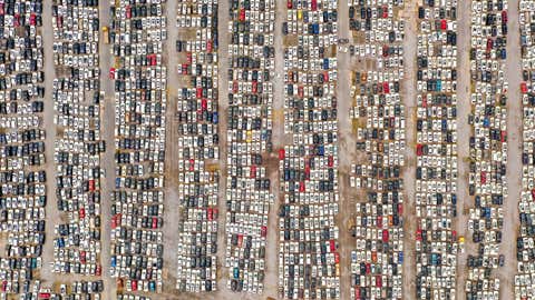 An aerial view shows cars with water damage, which have been compensated by the insurance companies to the car owners, at a parking lot of a third-party service company in Zhengzhou city in central China’s Henan province Tuesday, August 10, 2021. The local trade association estimated over 400,000 vehicles suffered water damage in the July 20 flood in Zhengzhou. (Feature China/Barcroft Media via Getty Images)