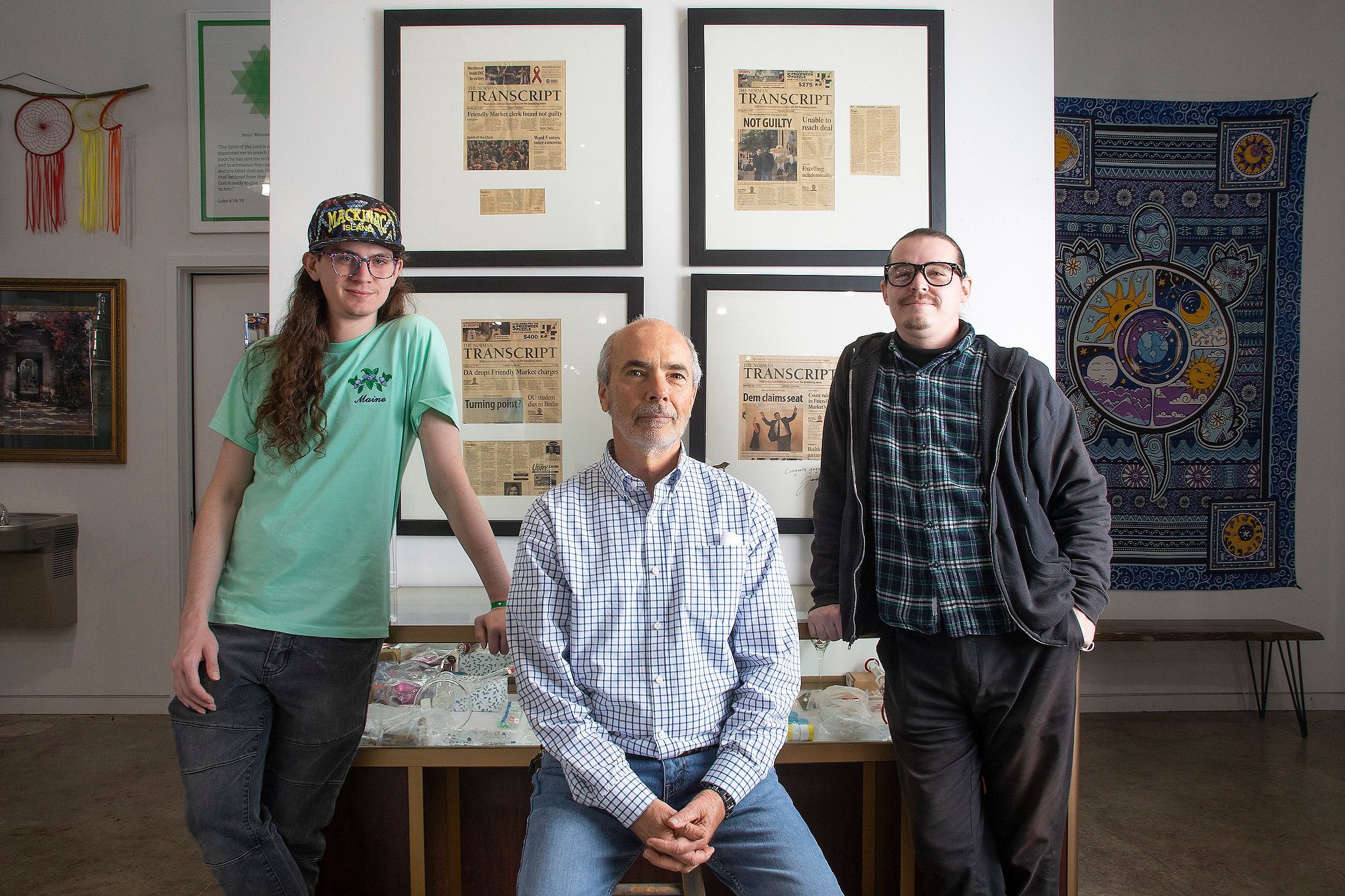 Left to right: The Friendly Market’s Max Walters, Robert Cox and Stephen Holman stand in front of a display of memorabilia documenting their succesful two-year legal battle over criminal charges for allegedly selling drug paraphernalia prior to the legalization of medical marijuana in Oklahoma.