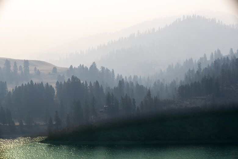 Early morning smoke hangs in the air Wednesday at the Sanpoil River Arm north of the Columbia River in Eastern Washington. Wildfires have left a blanket of thick smoke throughout parts of the  state. (Amanda Snyder / The Seattle Times)