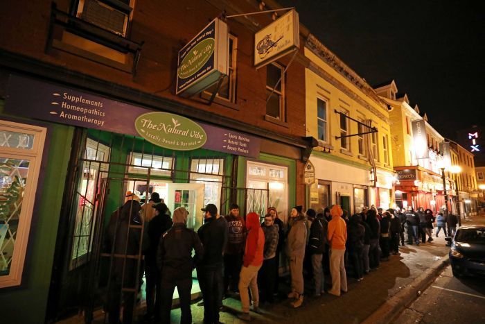 Customers line up outside the Natural Vibe store after legal recreational marijuana went on sale in Canada.