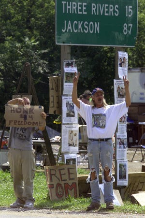 Timothy Dorrier Jr., (left) and Morel Moses Yonkers, both of Elkhart, campaign for the freedom of Tom Crosslin along Michigan 60 in Vandalia on Sept. 3, 2001.