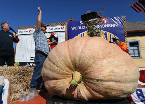 HALF MOON BAY, CA - OCTOBER 11: Jeff Uhlmeyer of Olympia, Washington celebrates his win at the Safeway World Championship Pumpkin Weigh-Off on Monday, Oct. 11, 2021, in Half Moon Bay, Calif.  Uhlmeyer won the annual competition with a pumpkin weighing 2191 pounds.  (Aric Crabb/Bay Area News Group)